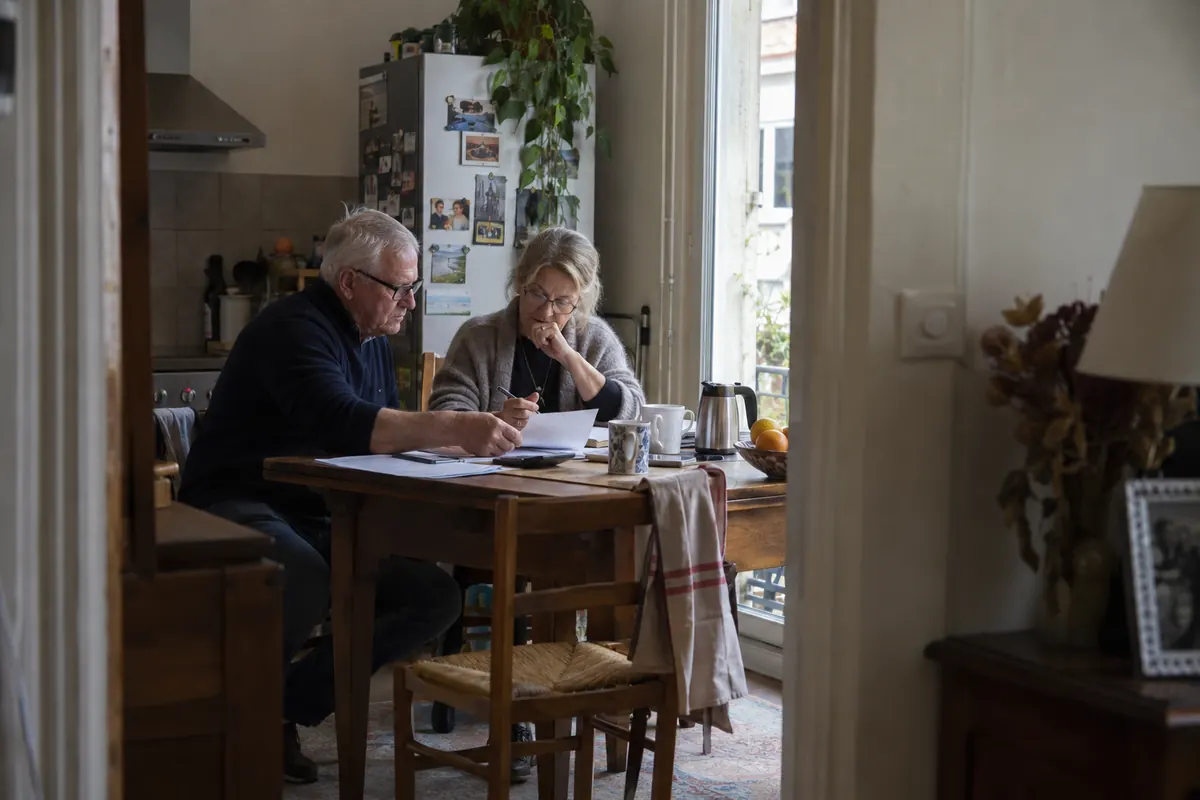 Couple préparant son budget à table — image d’ambiance générée par IA